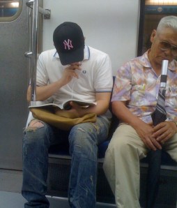 Korean Guy Wearing Baseball Cap on Train Korean Guy Wearing Baseball Cap on Train